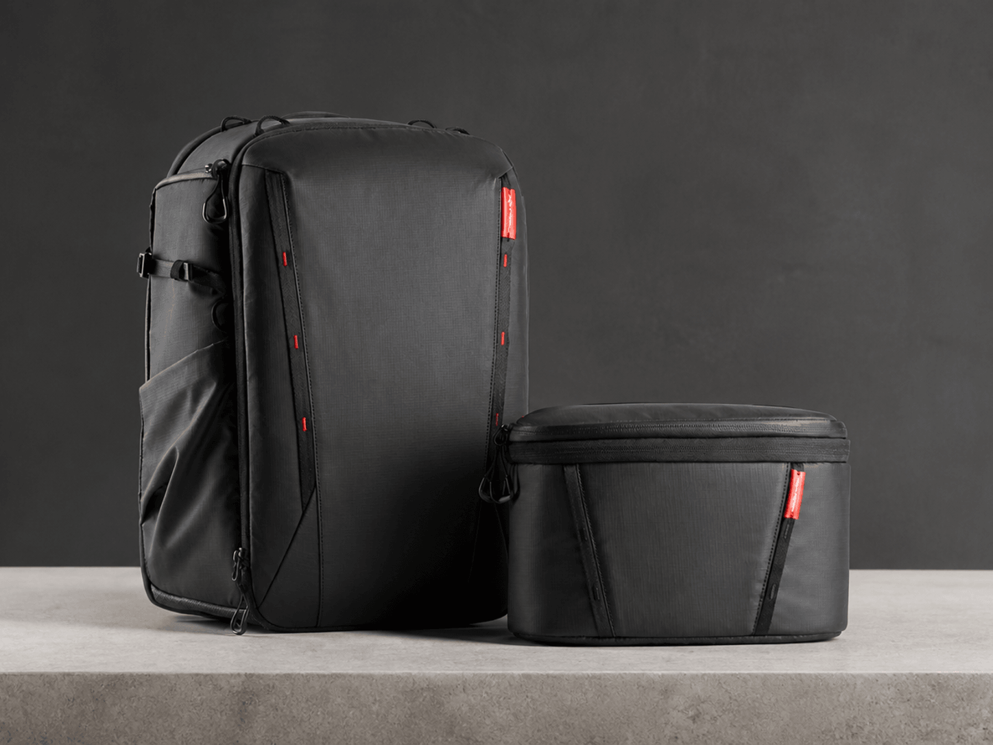 PGYTECH OneMo 2 black camera backpack with its removable shoulder bag on a neutral studio surface