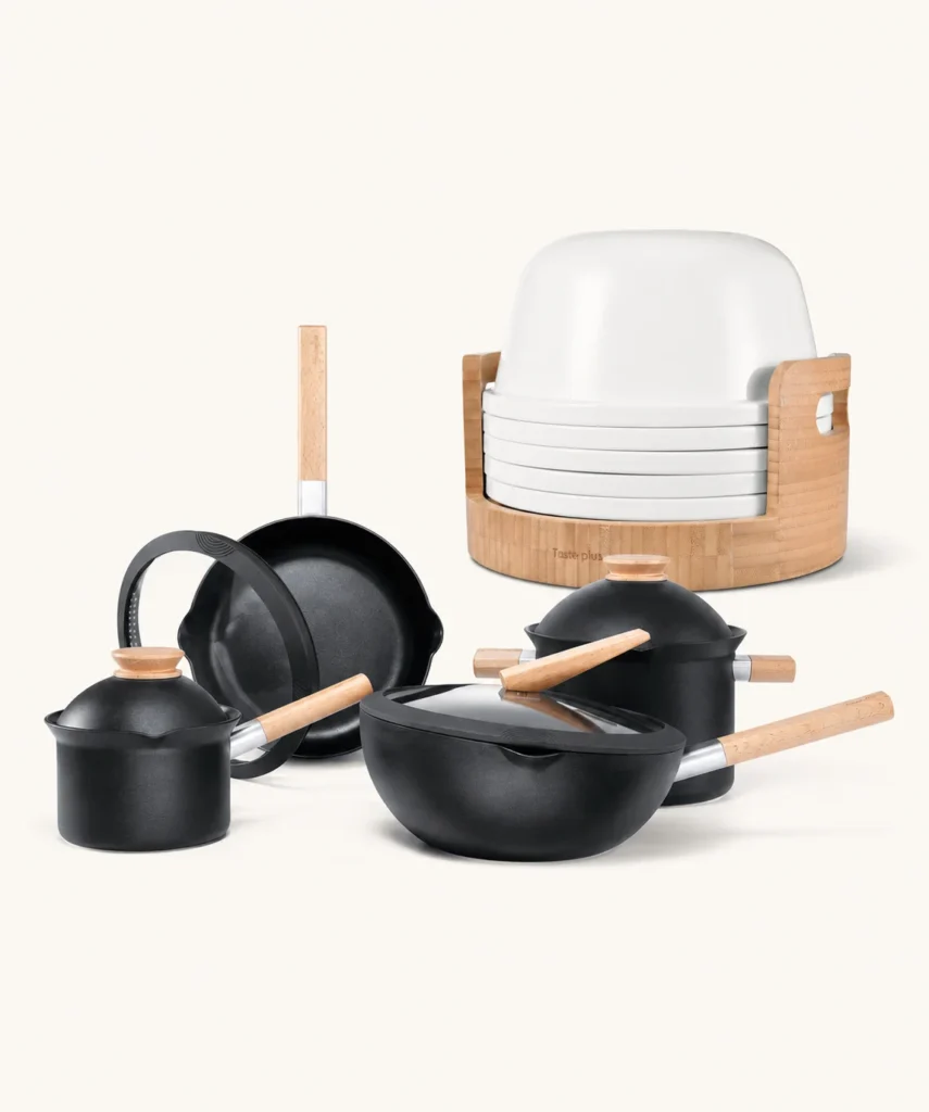 Black Taste Plus Yuanmu cookware and white porcelain storage dining set on a warm studio background
