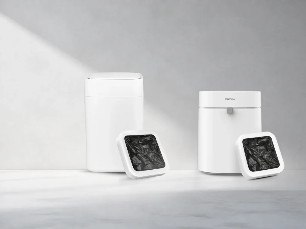 TOWNEW T1 automatic trash can and compact T Air Lite waste bin arranged in a cool grey studio setting