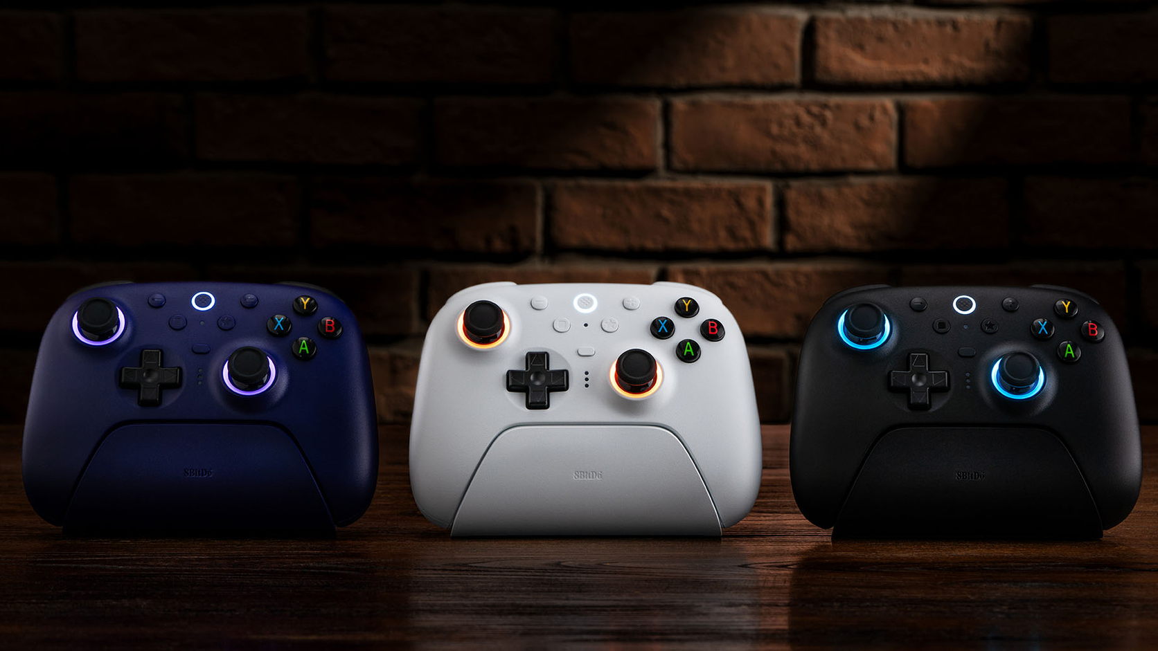 Wide official scene showing three colour versions of the 8BitDo Ultimate 2 Wireless Controller
