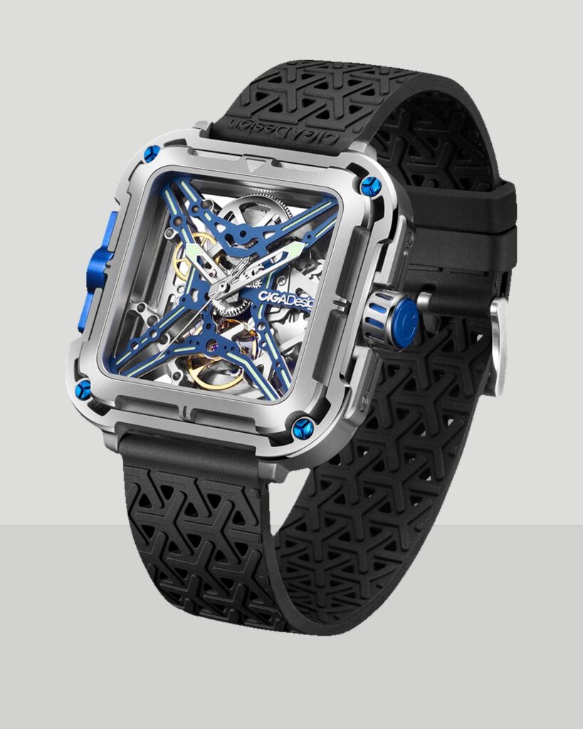 Complete CIGA design Gorilla skeleton watch with square case and black perforated strap on a neutral field