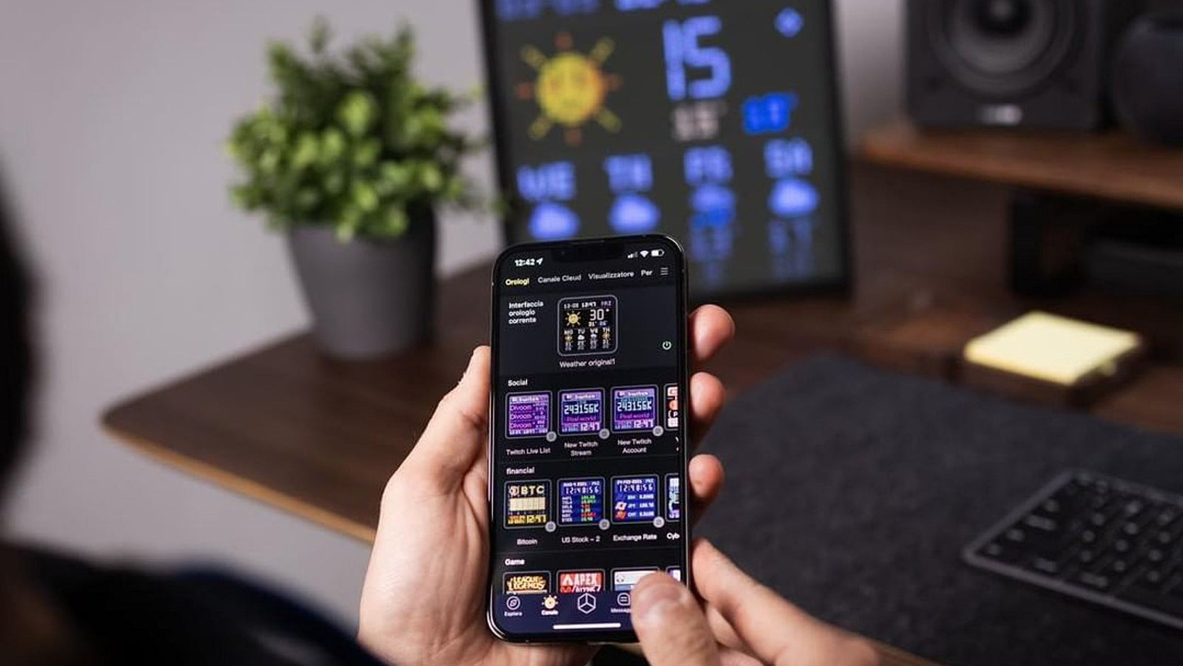 Divoom Pixoo-64Ⅱ operating as a desktop information display behind a phone running the Divoom app