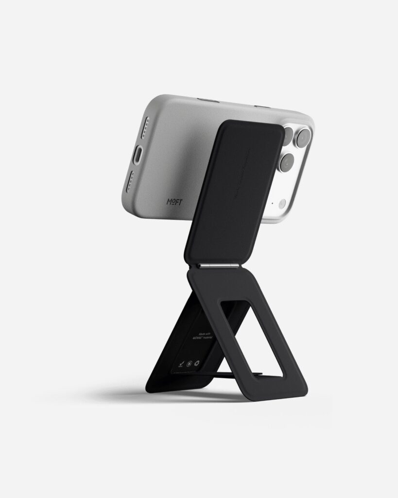 Complete black MOFT Snap Phone Tripod Stand MOVAS holding a phone in landscape position on a clean neutral background