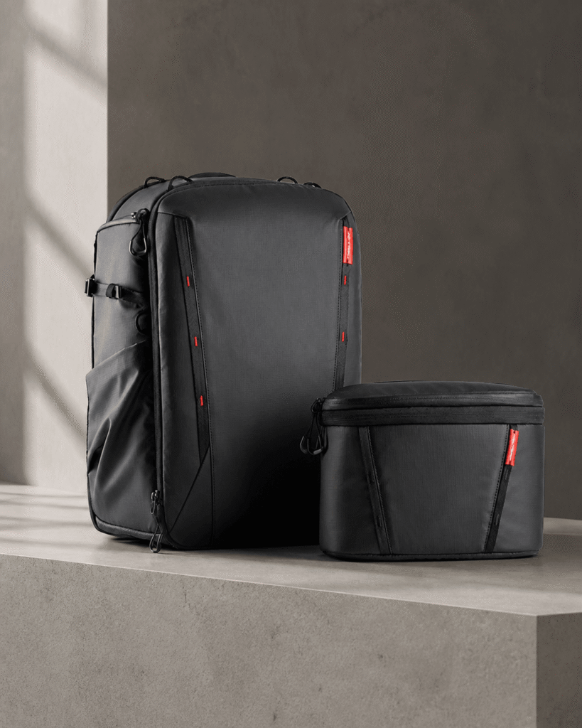 PGYTECH OneMo 2 black camera backpack and removable shoulder bag on a dark studio background