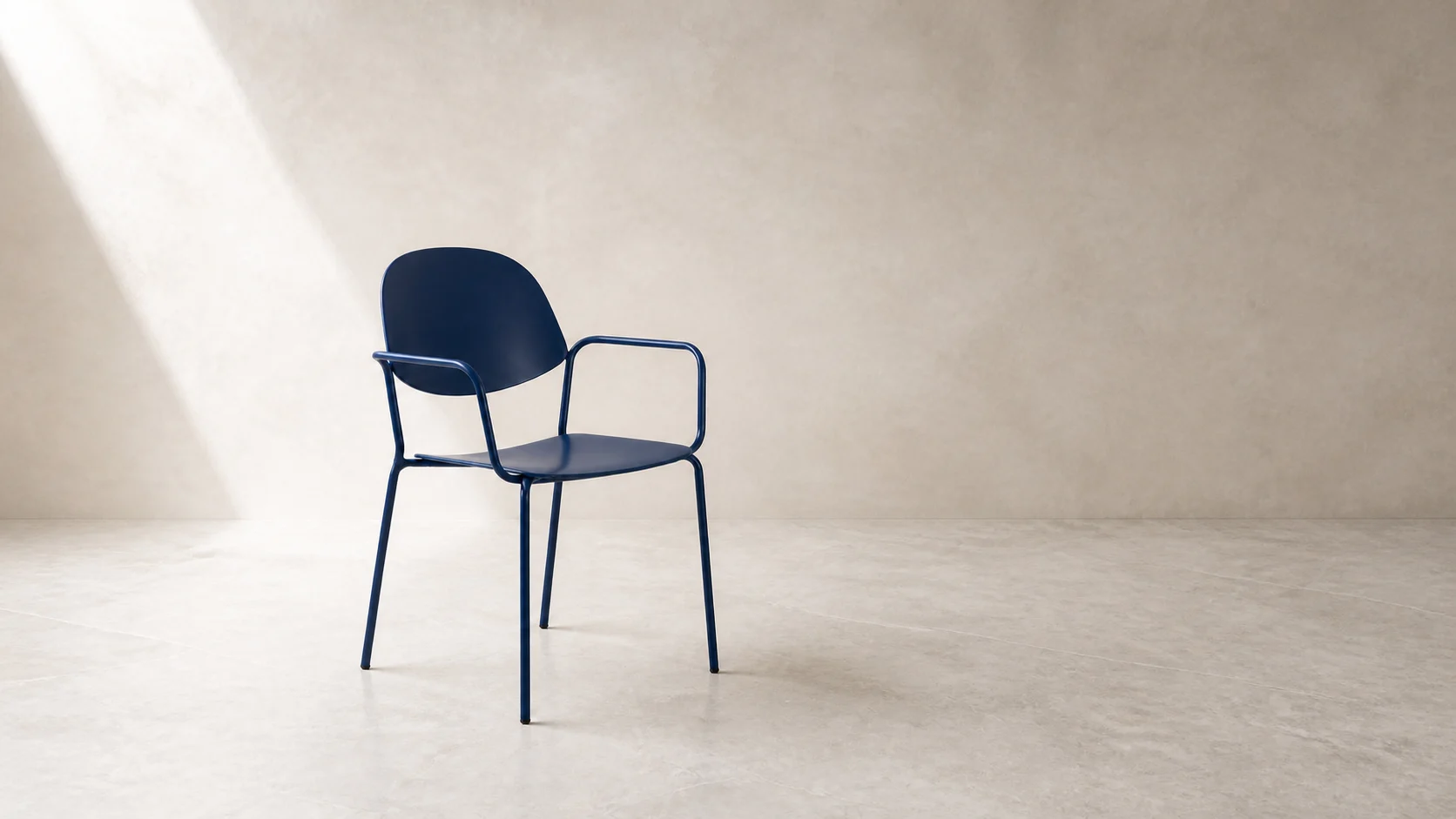 Wide studio view of the navy ZAOZUO Lili Chair showing its open tubular frame and curved back