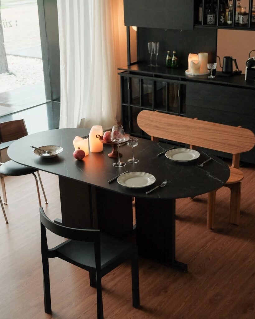 Complete dark ziinlife Dimension dining table shown with chairs in a furnished room